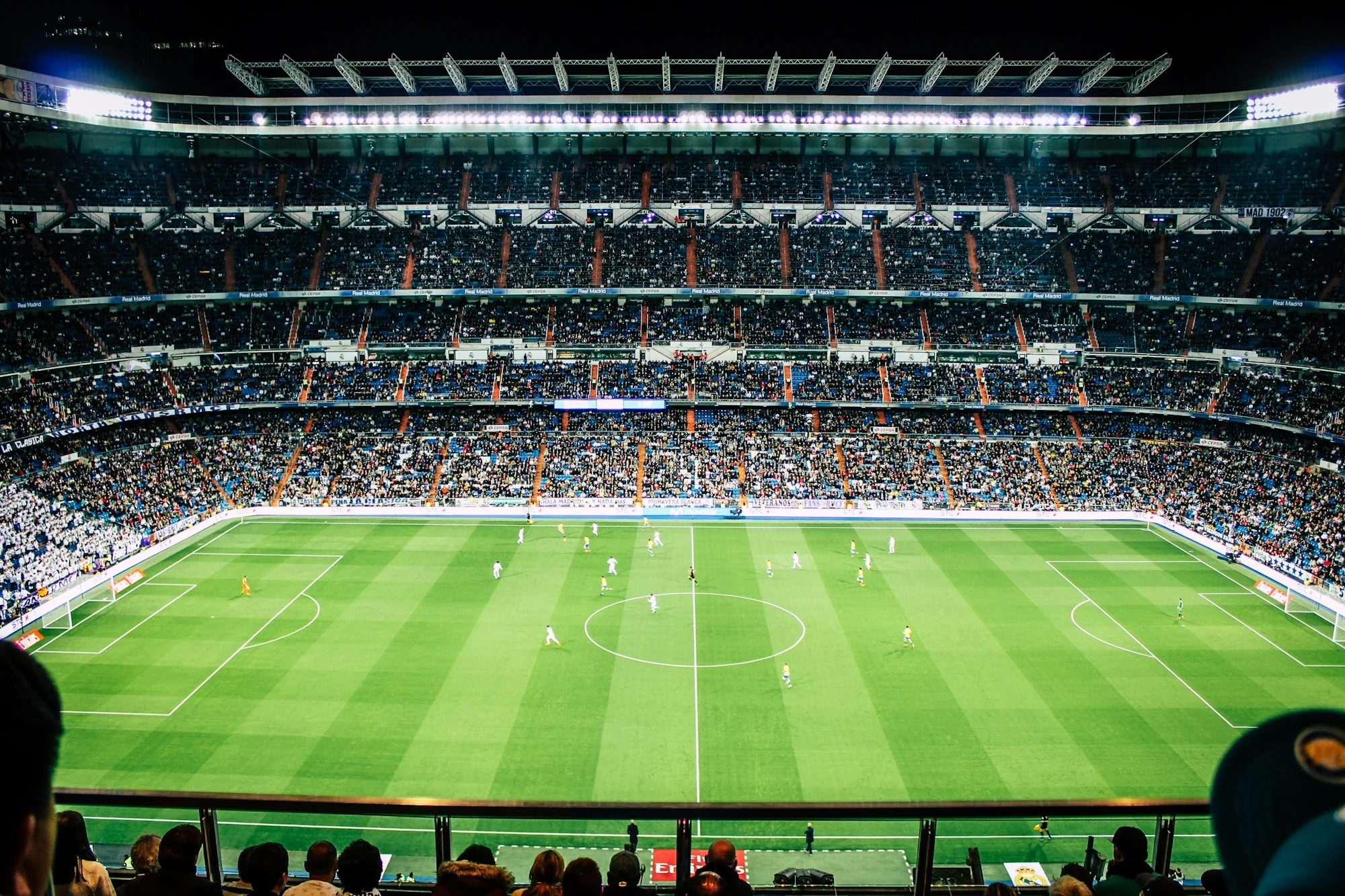 The atmosphere of a floodlit football stadium